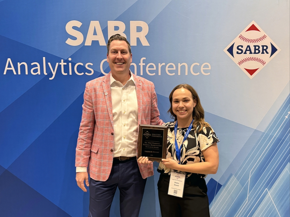 Kristen Stewart posing with award plaque