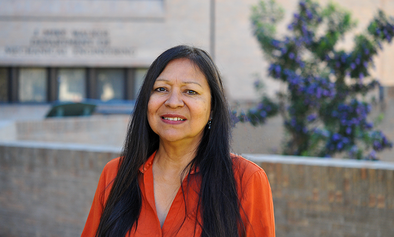 Yolanda Soriano smiling in front of Walker Department of Mechanical Engineering building on UT Austin campus.