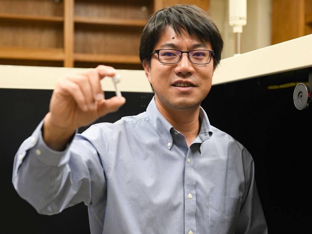 Yijin Lu holding battery