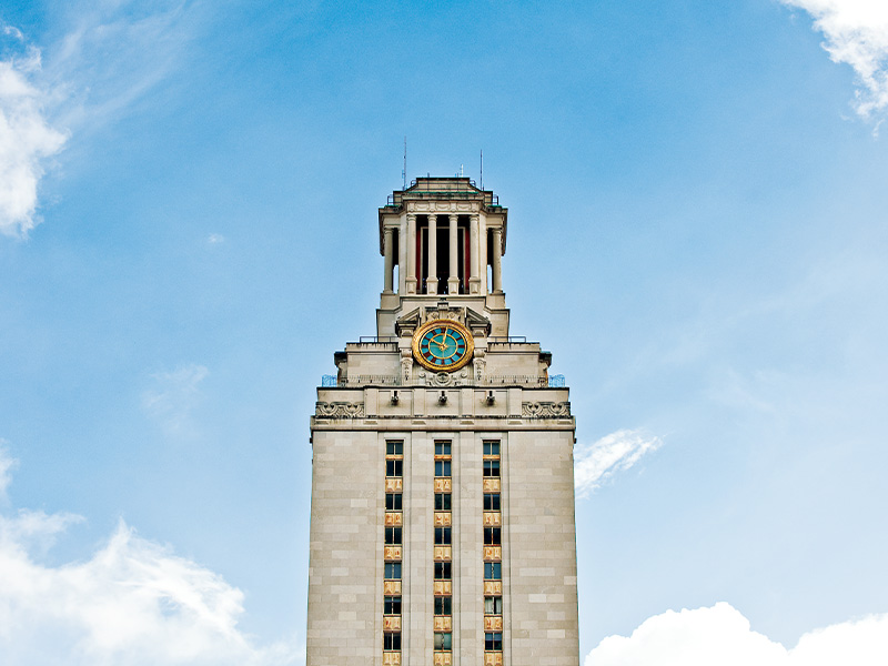 UT Tower from below with a slightly cloudy sky in the background