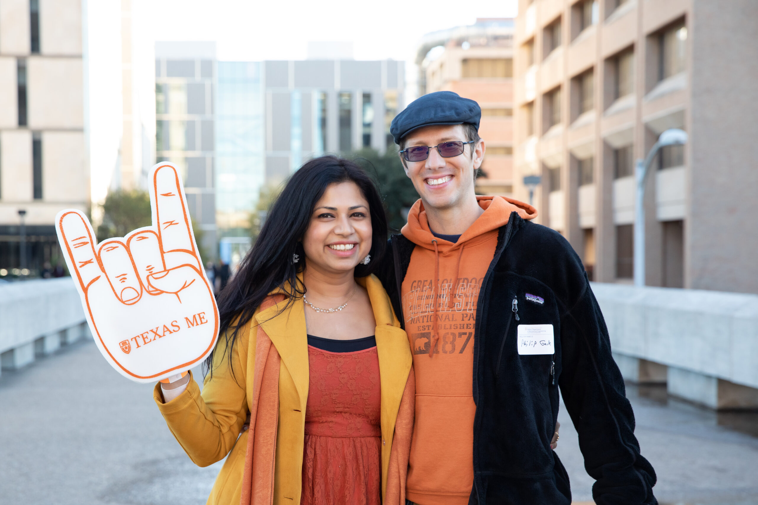 man and woman at tailgate holding a foam finger