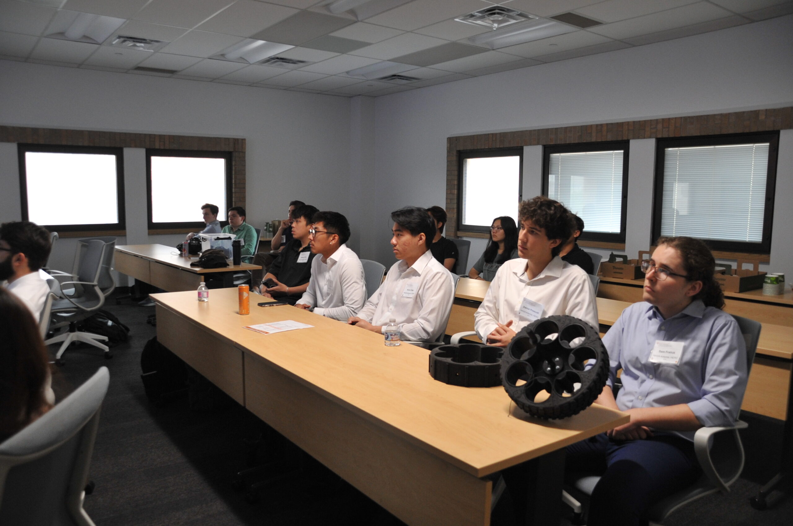 Students in a classroom watch project demonstrations.
