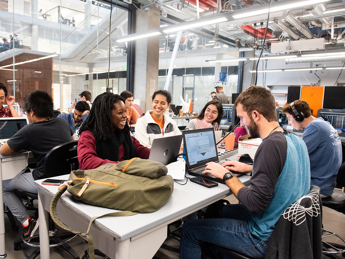 students working at a table in Inventionworks maker space
